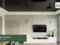 Nowoczesny salon z telewizorem na tle betonowej ściany. Lustrzany sufit napinany dodaje głębi, a subtelna **faseta** podkreśla elegancję wnętrza.