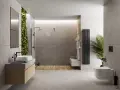 Nowoczesna łazienka z zieloną ścianą i betonem architektonicznym. Mikrocement na płytki nadaje jej surowego, ale eleganckiego charakteru.