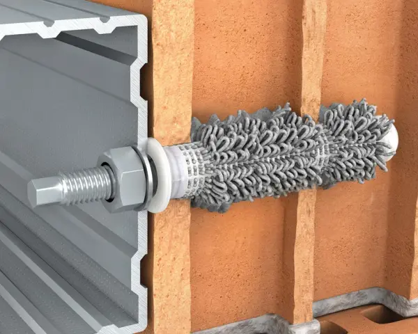 Przekrój przez cegłę pokazuje, jak kotwy chemiczne mocują profil aluminiowy.
