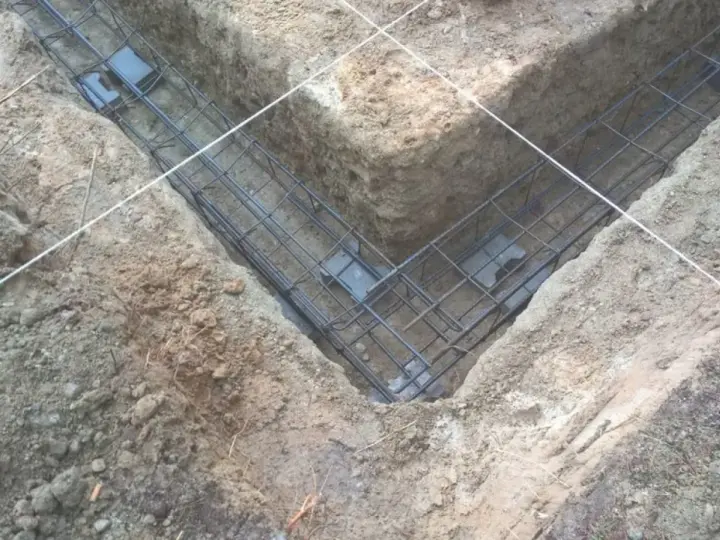 Zbrojenie fundamentów w wykopie. Różne rodzaje betonu zostaną tu wkrótce wylane, tworząc solidną podstawę.